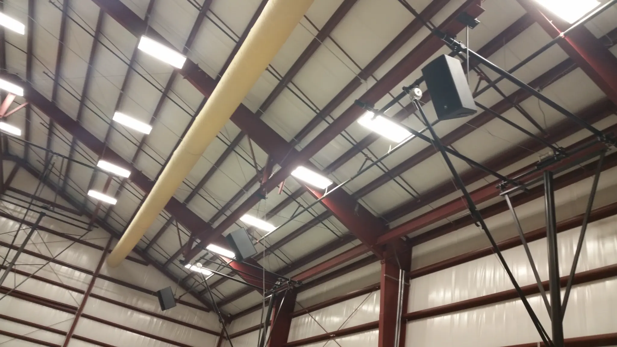Cornerstone Prep Academy gymnasium ceiling with multiple PA speakers and lighting rig