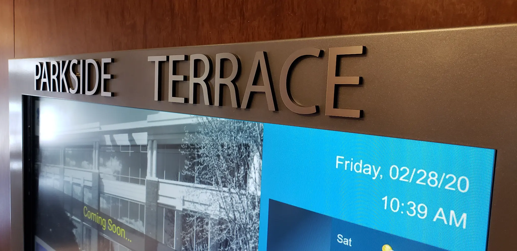 Close-up of Parkside Terrace signage with digital display showing date and time