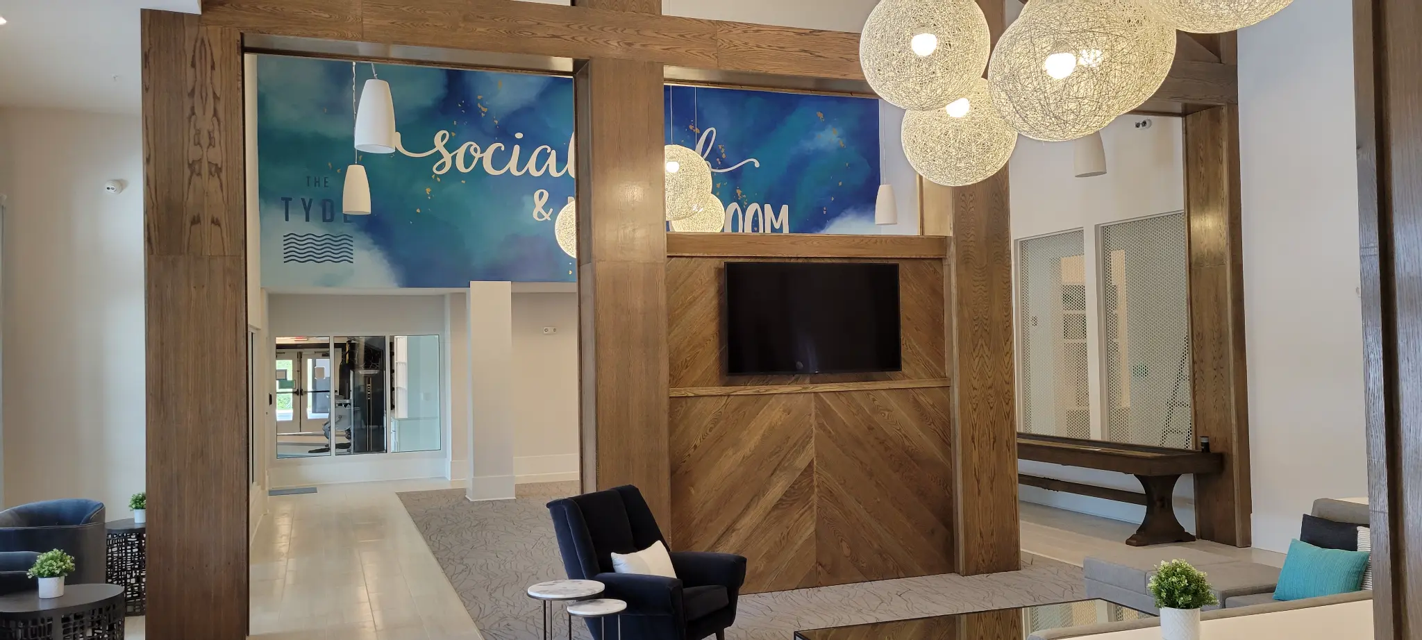 The TYDE multi-family property lobby showing integrated commercial AV and displays