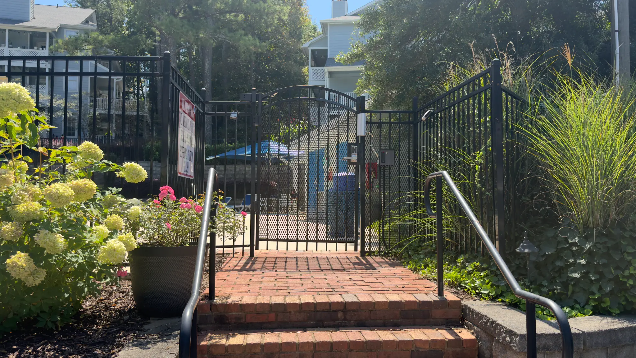 Landscaped approach to The Willows HOA pool gate with access control