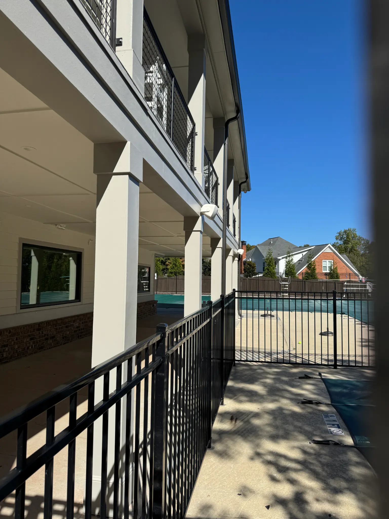TUXFORD HOA clubhouse walkway and fenced pool area