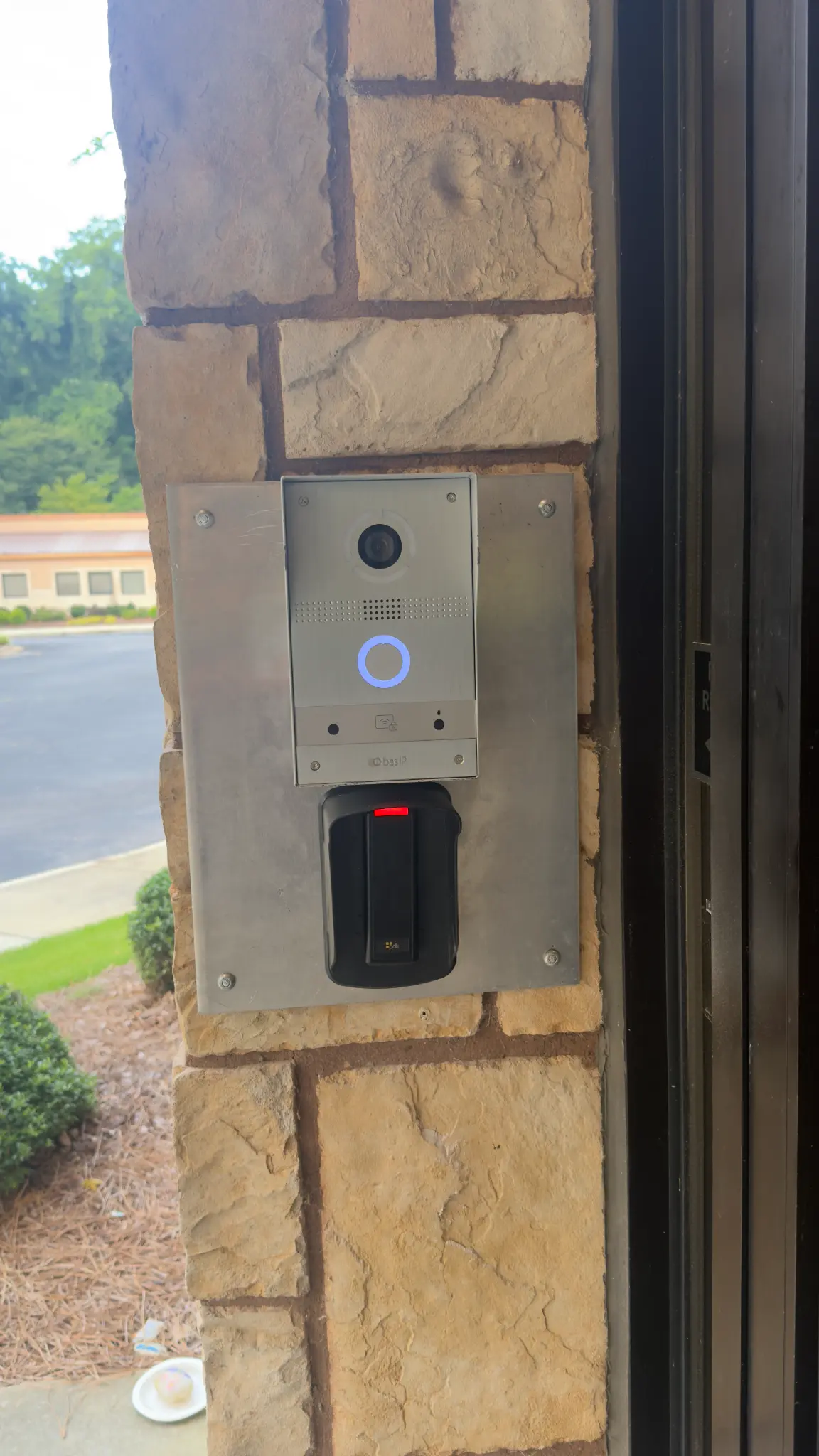 BAS-IP video intercom and PDK card reader mounted on stone wall at TBT entrance