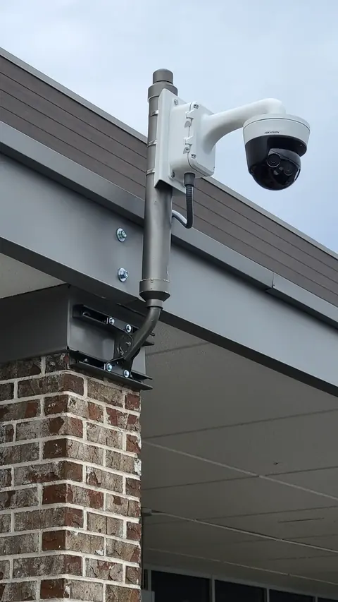 Hikvision dome security camera mounted on exterior wall at Chamblee Plaza