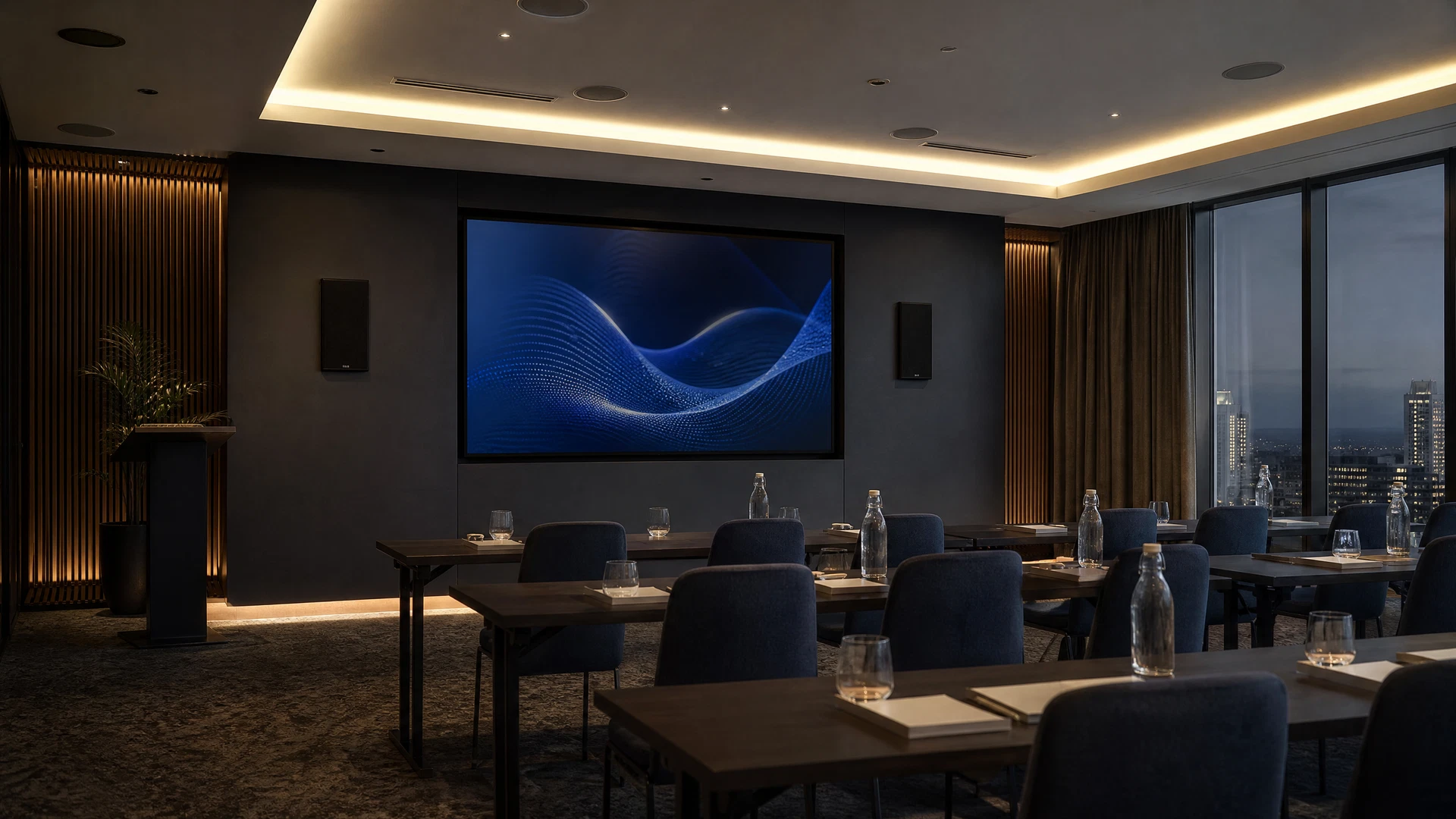 Modern corporate training room with a large wall-mounted commercial display and integrated audio